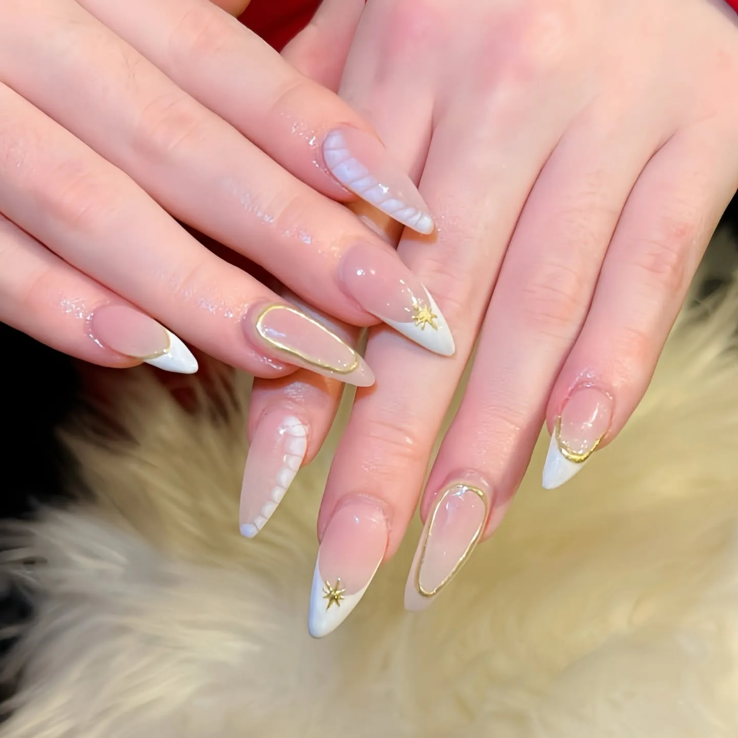 Nude almond nails with gold wire outlines and gold starburst art